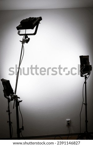 LED panel lights in front of a white wall as a portrait studio setup.
