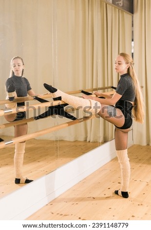 Ballerina in pointe pose. Beautiful ballet dancer stretching in class. Ballerina woman training
