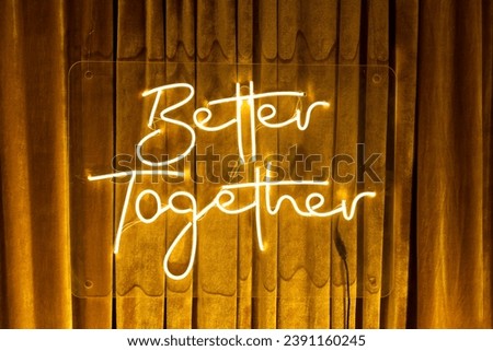 Better Together white neon sign. Glowing neon lettering Better Together template in golden velvet window curtain background