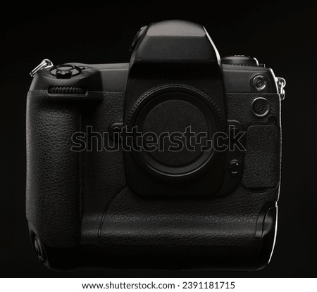 Professional digital single lens reflex camera over black background