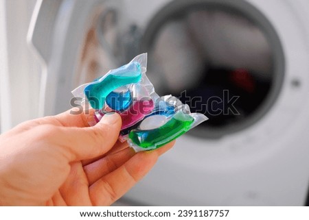 Washing machine detergent in pod form, with plastic that dissolves in water inside the washing machine.
