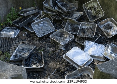Many Disposable Grills, Used Grill Piles, Barbecue Garbage with Foil Pans, Human Waste, a lot of Disposable Grills after Success Company Party, Corporate Trash Royalty-Free Stock Photo #2391194953