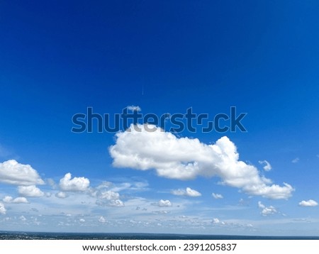 Fluffy Clouds on Blue Sky backgrounds and Land with Copy Space. Cloudscape Snapshot Photo, At Wat Roi Phra Putthabat Phu Manorom, Mukdahan, Thailand 11Nov2023
