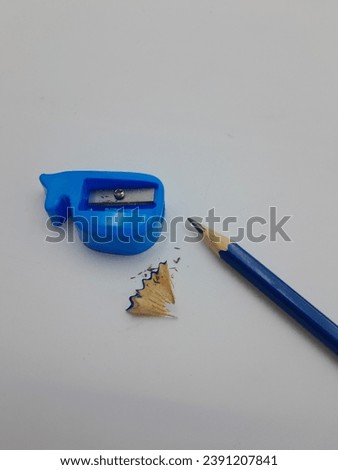 a trash pencil sharpener along with a blue sharpener on a white background
