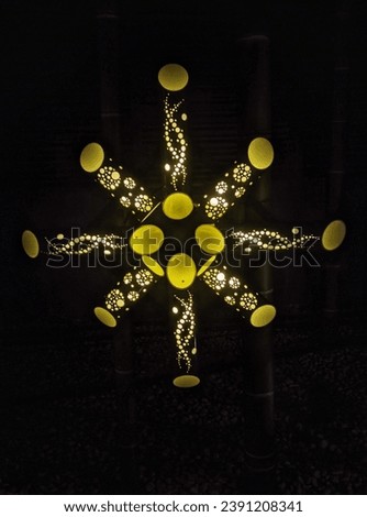 A lighted snowflake in the shape of a star, Beautiful picture of golden fireflies lights.