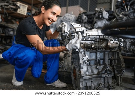 Female auto mechanic are repair and maintenance auto engine is problems. Engineer inspecting motor part problems. Woman empowerment working in automotive maintenance service industry.