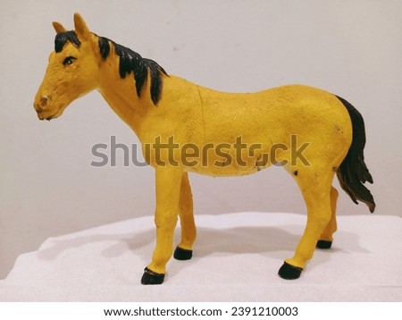 The yellow brown horse toy stands alone