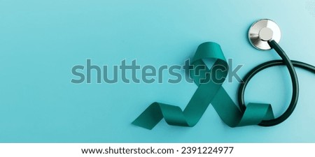 Ovarian and Cervical Cancer Awareness. a Teal Ribbonin with Stethoscope in Top View. Uterus, Female Reproductive System, Women's Health, PCOS and Gynecology  Royalty-Free Stock Photo #2391224977