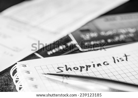 Shopping list, a notebook with shopping list and a credit cards 