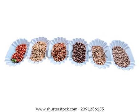 Pictured are various types of coffee, including raw, dried, roasted, and red-ripened coffee, arranged in white containers with various colors.