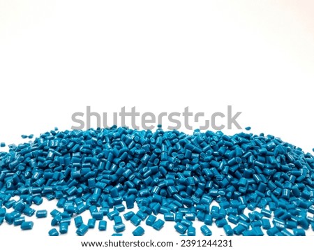 Greenish blue masterbatch granules isolated on a white background, this polymer is a colorant for products in the plastics industry