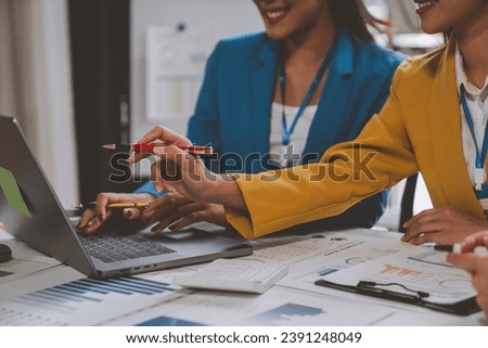Team of creative businesswomen plan strategic analysis and brainstorm with financial reports, tax documents, calculations, analyze marketing processes with laptops in the office.