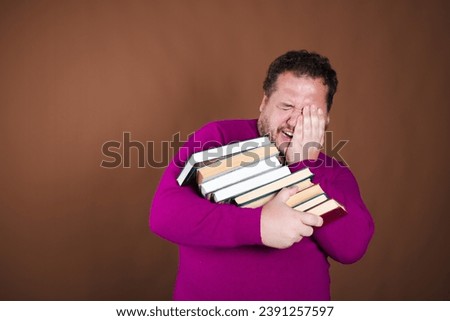 Funny librarian and important books. A man posing against a brown background.