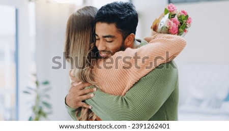 Man, woman and hug with bouquet in home with roses for smile, care or love on birthday, anniversary and event. Couple, flowers and happy for present, gift or surprise for bonding, romance or together Royalty-Free Stock Photo #2391262401