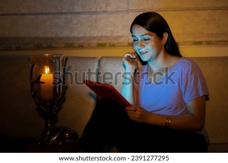 Beautiful young woman using digital tablet at home