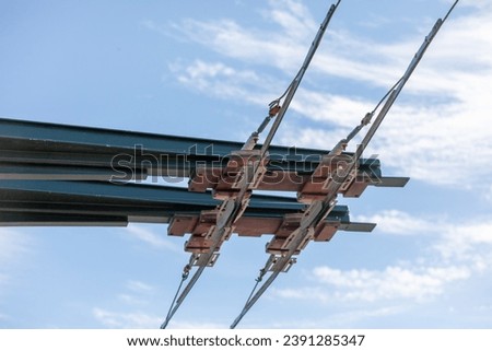 Trolleybus wires against the sky. Royalty-Free Stock Photo #2391285347
