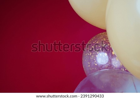 Light balloons - white, beige, transparent, pearl on a red background. Horizontal photo. Space for text