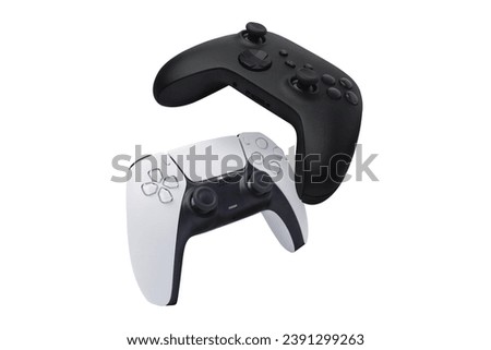 Black and white game controllers falling isolated on white background
