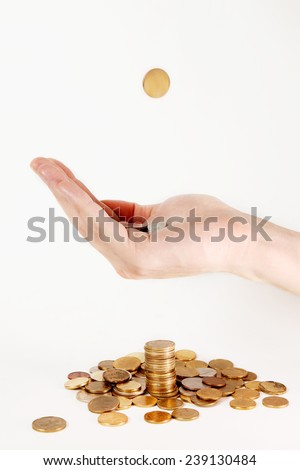 Financial education , Hand catching one more coin over the stack of coins