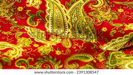 Paisley green pattern on a red background. decorated the bandanas of cowboys and bikers popularized by The Beatles, ushered in the era of hippies and became the emblem of rock and roll.
