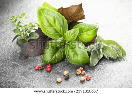 Herbs and spices over black stone background. Top view.
