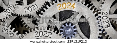 Photo of tooth wheel mechanism with numbers 2024, 2023, 2022 imprinted on metal surface. New Year concept. Royalty-Free Stock Photo #2391319213