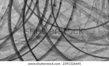 Aerial view tire track mark on asphalt tarmac road race track texture and background, Abstract background black tire track skid on asphalt road, Tire mark skid mark on asphalt road. Royalty-Free Stock Photo #2391326445