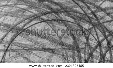Aerial view tire track mark on asphalt tarmac road race track texture and background, Abstract background black tire track skid on asphalt road, Tire mark skid mark on asphalt road. Royalty-Free Stock Photo #2391326465