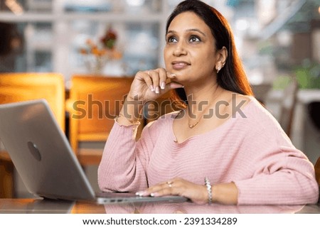 Beautiful woman working on laptop at home
