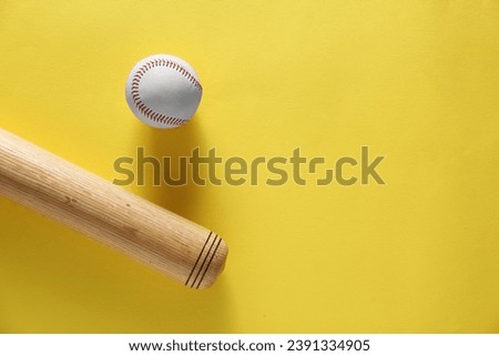 Baseball bat and ball on yellow background, flat lay. Space for text