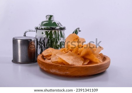 taro chips, bamboo plate and green zinc teapot with white begron