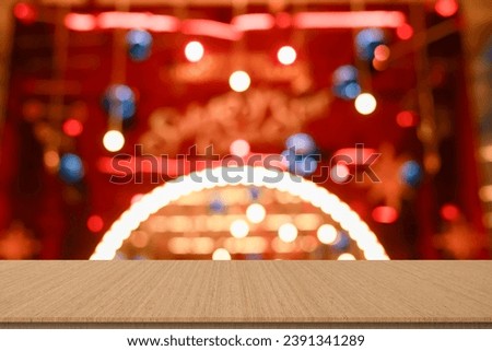 abstract blur red color decorated christmas stage ornament in fair carnival background with modern wood perspective tabletop for show,ads,design product on display concept in merry xmas season concept