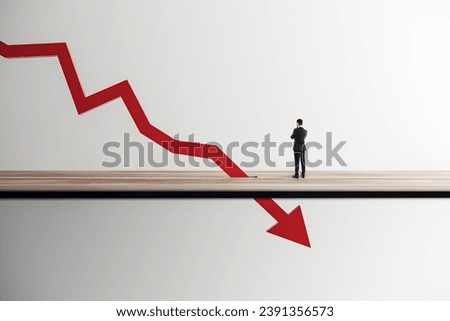 Executive facing a giant declining red arrow Royalty-Free Stock Photo #2391356573