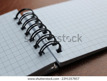 Clean Pages Of Spiral Checkered Notebook On Expensive Leather Macro Shot Photo
