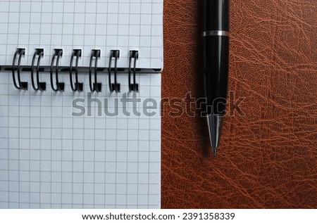 Binder Notepad With White Pages And Opened Pen On A Leather Folder Stock Photo For Title Or Business Logo
