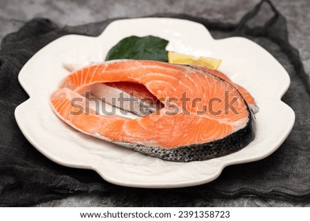 slice of fresh raw fish salmon on white plate
