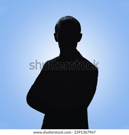 Silhouette of a man. Man posing in a suit on a blue background
