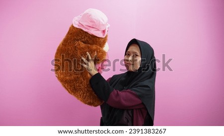 beautiful woman carrying a teddy bear