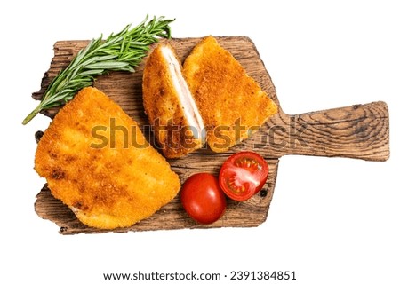 Crispy Cordon Blue Chicken fillet roll with ham and cheese served on a wooden board. Isolated, white background Royalty-Free Stock Photo #2391384851