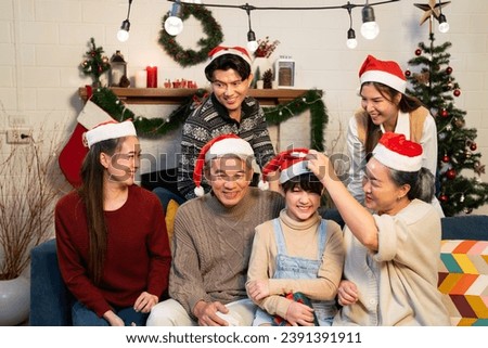 Merry Christmas winter party in Asian family home including grandparent, father, mother, sister and daughter joy and fun together for take a picture of memory in giving season holiday