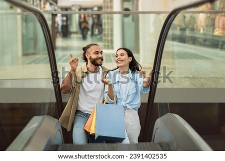 Glad millennial european family shopaholics customers with many packages enjoy walk, customer lifestyle at spare time, fun in mall. Sale, shopping presents together, ad and offer Royalty-Free Stock Photo #2391402535