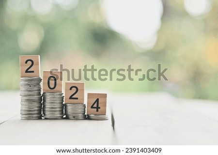 close up stack of coin and 2024 wooden text block on table, saving and manage to success business, countdown to new year, economic crisis risk and problem concept