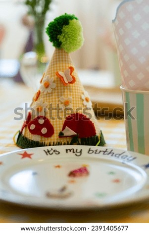 Birthday decorations - gifts, toys, balloons, garland and figure for little baby party on a white wall background.