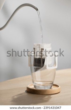 The hot water is poured over the roasted and ground coffee, in a filter paper ready to use. Royalty-Free Stock Photo #2391431047