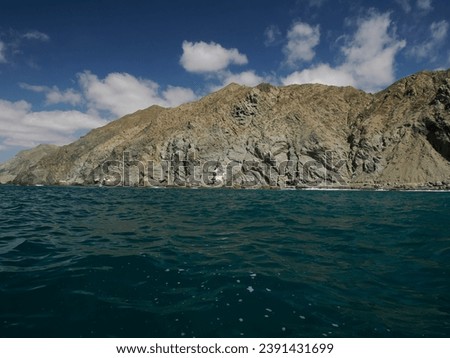 Panorama Landscape from the sea of Marguerite island coast over the pacific ocean volcanic rocks in baja california sur, mexico