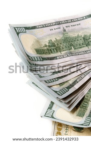 A stack of US 100 bills on a white background.  Synonymous with wealth and abundance. Royalty-Free Stock Photo #2391432933