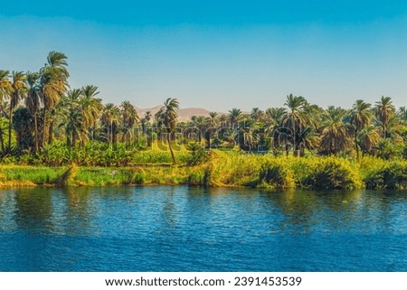 Picturesque scenery of the Nile River. Cruise on the Nile. View of the coastline.  Aswan, Egypt – October 20, 2023 Royalty-Free Stock Photo #2391453539