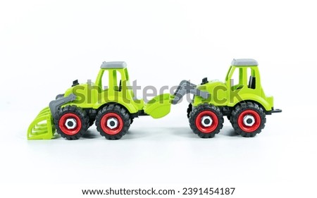 Group of cars ,Children's toy green tractor on a white isolated background.Plastic child toy on white backdrop. Construction vehicle. Children's toy. Tractor Toy.