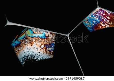 Close-up of soap foam bubbles with iridescent surface areas on a black background Royalty-Free Stock Photo #2391459087