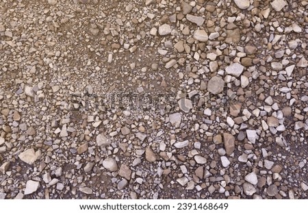 Background of shattered stony stones surface in mountain area. Flat texture with natural light